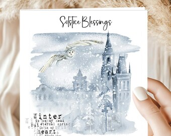 May include: A square greeting card featuring the text Solstice Blessings at the top and a watercolor illustration of a snowy winter scene with a flying owl, tall towers, and pine trees. The text Winter is on my head but eternal spring is in my heart by Victor Hugo is printed in the bottom left corner.