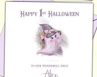 May include: A square greeting card featuring the text Happy 1st Halloween at the top and To Our Wonderful Niece Alice at the bottom. The center shows a light purple ghost wearing a dark purple witch hat with a pink bow and gold glitter accents.