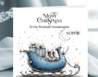 May include: A square greeting card featuring a blue sleigh filled with wrapped gifts and ice skates. The text reads Merry Christmas To Our Wonderful Granddaughter and includes the name SOPHIE next to a crescent moon illustration on a white background.