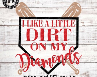 May include: A red and black baseball diamond graphic with two crossed baseball bats. The text "I like a little dirt on my diamonds" is written in red letters inside the diamond. The text "SVG DXF PNG" is written in black letters below the diamond.