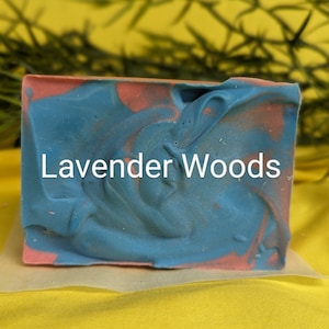 May include: A blue and pink marbled soap bar with the text "Lavender Woods" printed on the front.