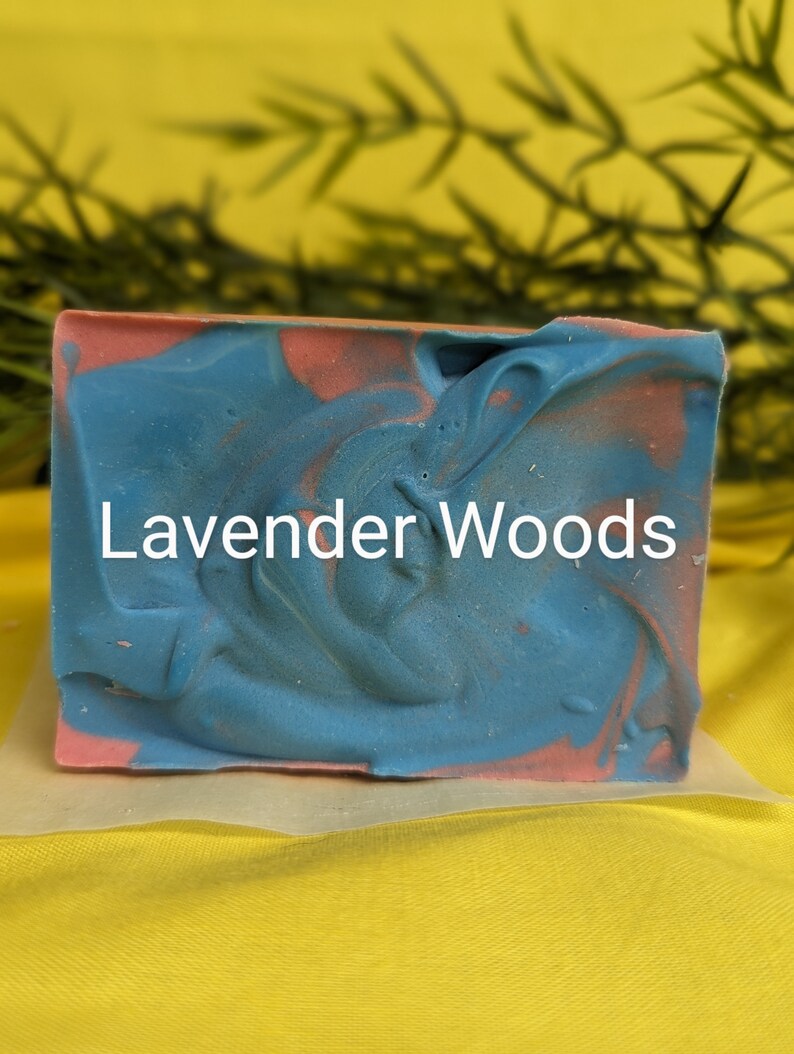 May include: A blue and pink marbled soap bar with the text "Lavender Woods" printed on the front.