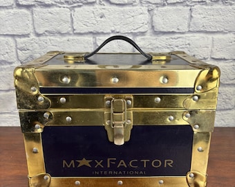 Maletín de viaje Max Factor Everlite, negro y dorado, años 40.