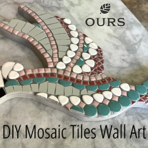 May include: DIY mosaic tiles wall art project featuring a dove-shaped piece with green, white, pink, and red tiles. The piece is mounted on a gray marble surface. The text "OURS" is visible in the upper right corner of the image.
