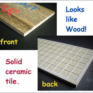 May include: A ceramic tile with a wood-look design on the front and a triangular pattern on the back. The tile is solid and looks like wood.