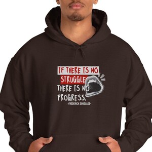 May include: A brown hooded sweatshirt with a white and grey graphic print that says "If there is no struggle there is no progress." -Frederick Douglass.