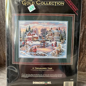 May include: The Gold Collection A Treasured Time counted cross stitch kit by Dimensions features a winter village scene with houses, people, and a frozen pond. The package includes 16 count dove grey Aida fabric, thread, and needle.