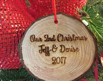 May include: A wooden Christmas ornament with the text "Our 2nd Christmas Jeff & Denise 2017" burned into the surface.