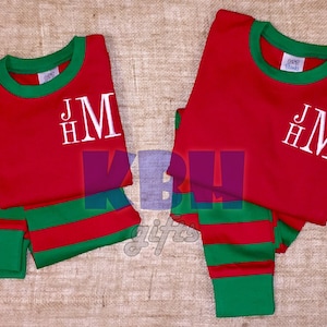 May include: Red and green striped pajamas with a white monogram that says "HMJ".