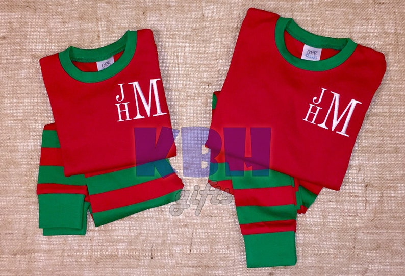 May include: Red and green striped pajamas with a white monogram that says "HMJ".