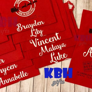 May include: Red fabric gift bags with white lettering. Each bag has a Santa Claus and reindeer graphic with the text "Express Delivery from the North Pole". The bags are personalized with names such as Peyton, Lizzy, Tyler, Brycen, Annabelle, Brayden, Lily, Vincent, Malaya, Luke, and Amelia.