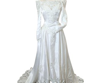 Vintage 80s wedding dress: Satin, long sleeves, boat neck, flowy skirt, cutout lace. Big bow. Matching veil. Basque waist. USA made. Sml.