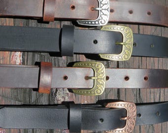 May include: A collection of leather belts with decorative metal buckles. The belts are in various shades of brown and black, with silver, gold, and copper-toned buckles. The buckles feature ornate floral and scroll designs. The belts are displayed on a wooden surface.
