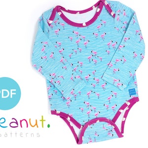 May include: A blue and pink long-sleeved baby bodysuit with a flamingo print. The bodysuit has a pink trim around the neckline and the bottom. The text "Peanut Patterns" is visible in the lower left corner of the image.