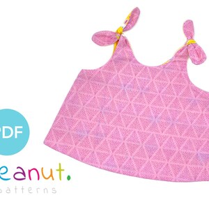 May include: A pink sleeveless top with a geometric pattern and yellow knotted straps. The top is made of a soft, lightweight fabric and has a relaxed fit. The top is perfect for summer days and can be dressed up or down.