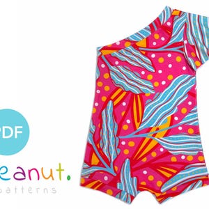 May include: A pink, blue, and yellow one-shoulder swimsuit with a floral print. The swimsuit has a ruffle on the shoulder and a short leg.