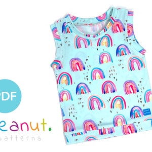 May include: A sleeveless, light blue shirt with a rainbow pattern. The shirt has a round neckline and a small label that says "peanut patterns".