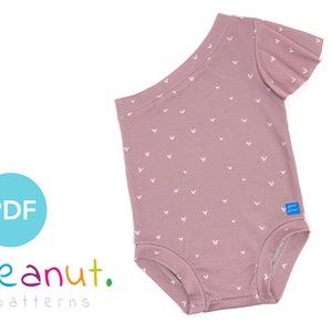 May include: A pink one-shoulder bodysuit with a white heart print and short sleeves. The bodysuit has a ruffled sleeve and a snap closure at the bottom. The text "peanut. patterns" is visible in the image.