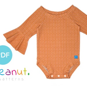 May include: A PDF pattern for a baby bodysuit with a geometric print and bell sleeves. The bodysuit is orange with a white pattern. The pattern is called "peanut. patterns".