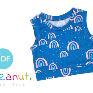 May include: A sleeveless blue tank top with a rainbow print and white polka dots. The tank top has a round neckline and a small label that says "peanut patterns".