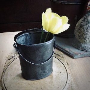 May include: A set of three ceramic mugs with a speckled, matte finish. The mugs are in shades of cream, light gray, and dark gray. Each mug has a simple, minimalist design, perfect for coffee or tea.