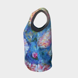 May include: A sleeveless tank top with a colorful floral print featuring shades of blue, pink, and white. The print resembles a watercolor painting.