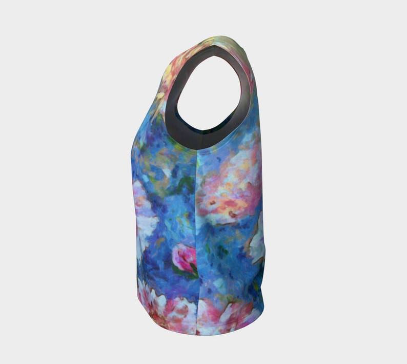 May include: A sleeveless tank top with a colorful floral print featuring shades of blue, pink, and white. The print resembles a watercolor painting.