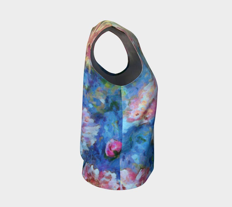 May include: A sleeveless tank top with a floral print featuring pink, blue, and white flowers on a blue background.
