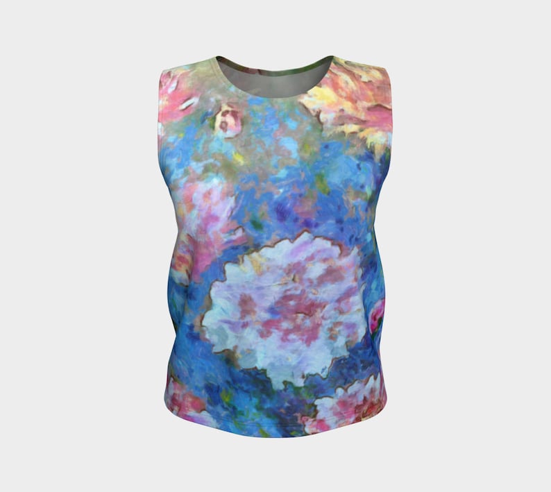 May include: A sleeveless tank top with a colorful floral print. The print features pink, blue, and white flowers on a blue background.