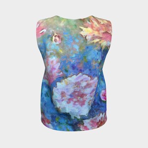 May include: A sleeveless tank top with a colorful floral print. The print features a variety of flowers in shades of pink, blue, yellow, and green. The background is a light blue color.