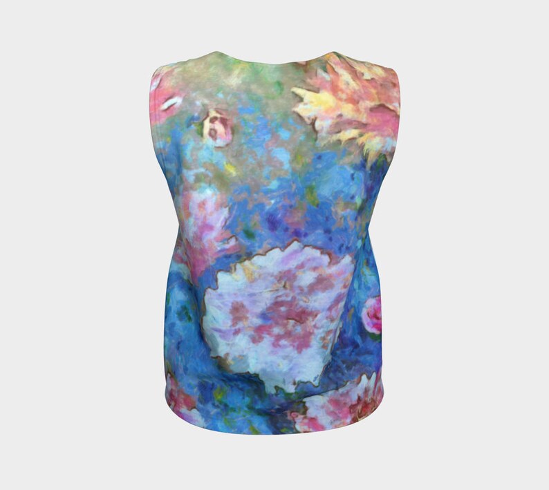 May include: A sleeveless tank top with a colorful floral print. The print features a variety of flowers in shades of pink, blue, yellow, and green. The background is a light blue color.