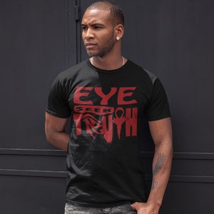 May include: A black t-shirt with a red graphic design that says "EYE SEEK TRUTH" with an ankh symbol.