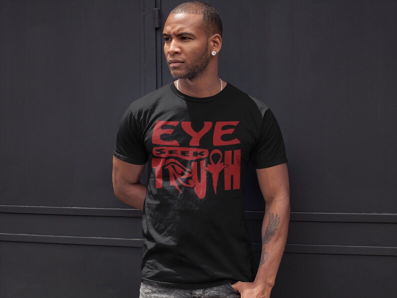 May include: A black t-shirt with a red graphic design that says "EYE SEEK TRUTH" with an ankh symbol.