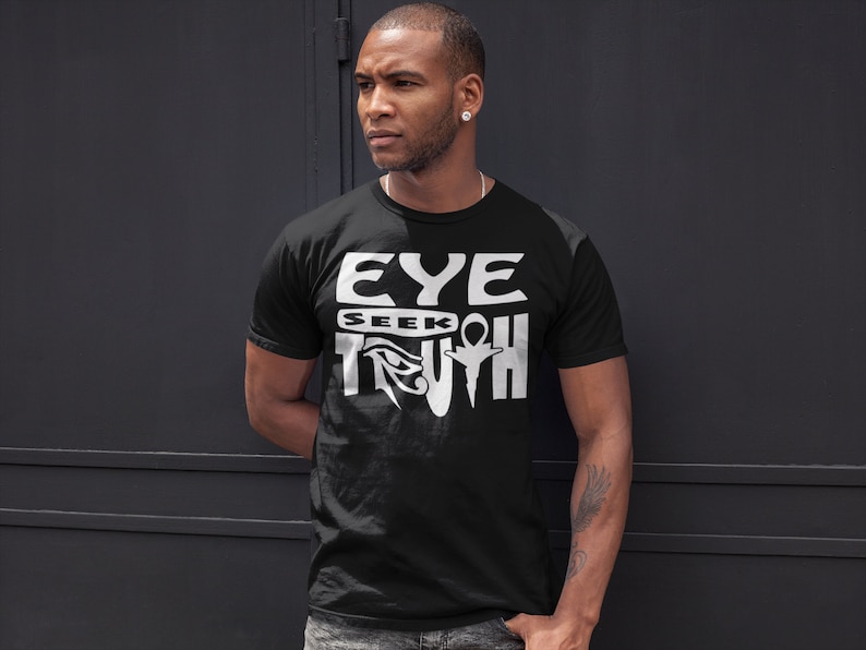 May include: Black t-shirt with a white graphic design that says "EYE SEEK TRUTH" with an Egyptian eye symbol.