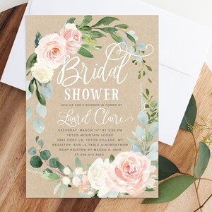 May include: A rustic brown invitation with a floral wreath border in shades of pink, white, and green. The text reads "Bridal Shower" and "Join us for a shower in honor of Laurel Claire". The invitation details the date, time, location, registry, and RSVP information.