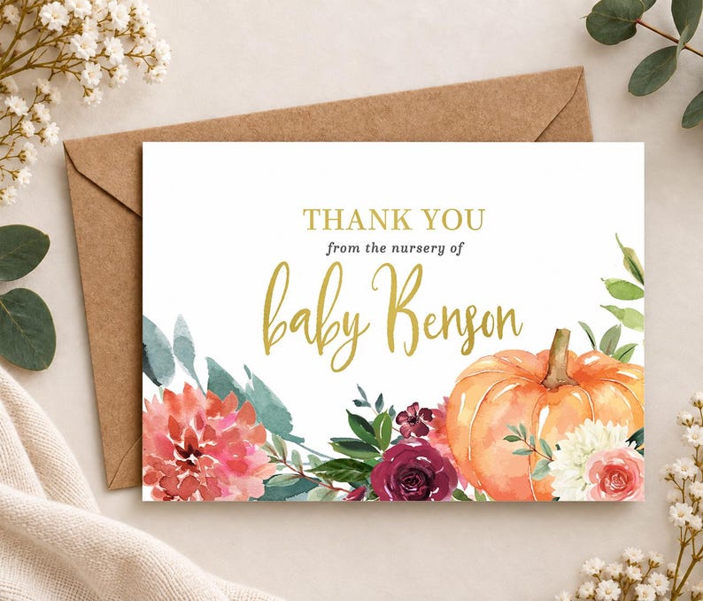 May include: A rectangular thank you card featuring the text THANK YOU from the nursery of baby Benson in gold and dark gray lettering. The design includes watercolor illustrations of a large orange pumpkin, red dahlias, and dark roses.