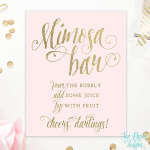 May include: A pink printable sign with gold glitter text that reads "Mimosa Bar" and instructions for making mimosas: "Pour the bubbly, add some juice, top with fruit. Cheers darlings!"
