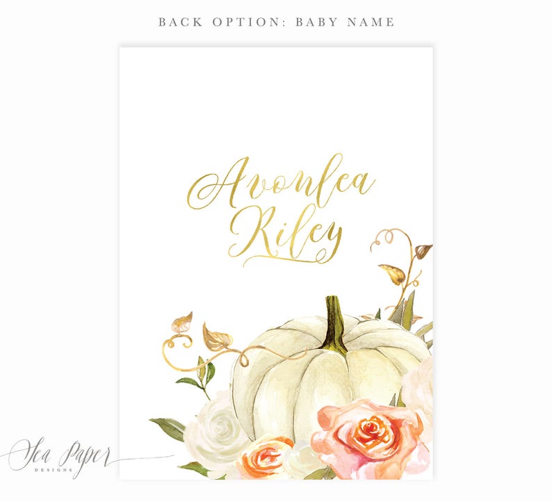 May include: A white pumpkin with a gold inscription that reads "Avonlea Riley" surrounded by white and peach roses and green leaves.
