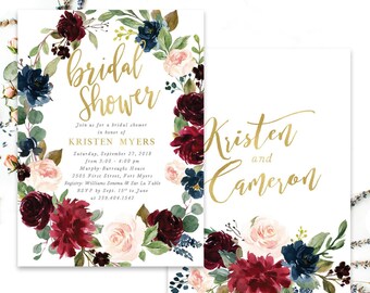 May include: Two white rectangular cards featuring a floral wreath design with burgundy, navy blue, and blush pink flowers and green leaves. The text reads bridal shower, Kristen Myers, and Kristen and Cameron in gold script and serif fonts.