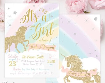 May include: Two rectangular baby shower invitations featuring a gold glitter unicorn silhouette, pastel rainbow background, and white clouds. Text includes It's a Girl, Leah Morgan, Baby Ainsley, The Pierson Castle, Dallas, Texas, and event details.