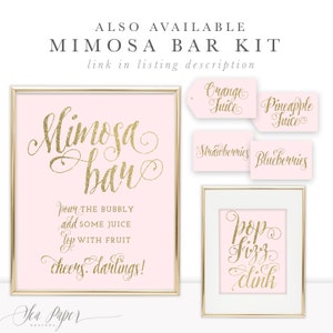 May include: A printable sign for a mimosa bar with gold glitter text on a pink background. The sign says "Mimosa Bar" and includes instructions for making mimosas. There are also four smaller signs with gold glitter text on a pink background that say "Orange Juice", "Pineapple Juice", "Strawberries", and "Blueberries".