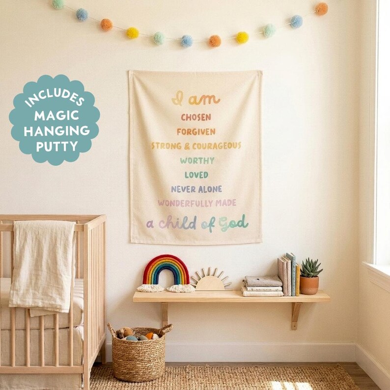 May include: A rectangular fabric wall hanging featuring pastel-colored text that reads: I am chosen, forgiven, strong & courageous, worthy, loved, never alone, wonderfully made, a child of God. A teal circular badge states: Includes magic hanging putty.