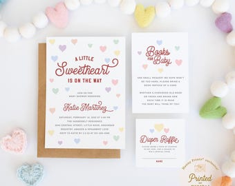 May include: A baby shower invitation set featuring a large card, a books for baby card, and a diaper raffle card. The white cards feature maroon text and small pastel-colored hearts. The invitation includes event details for Katie Martinez.