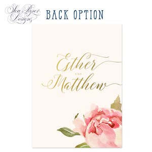 May include: Wedding invitation with a cream background and gold lettering. The names "Esther and Matthew" are written in a cursive font. A watercolor pink peony with green leaves is in the bottom right corner.