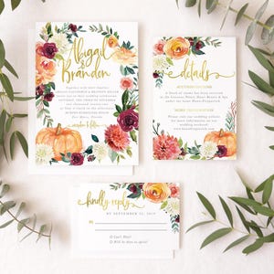 May include: A wedding invitation suite featuring three white cards with gold calligraphy and watercolor floral illustrations. The designs include orange pumpkins, deep red roses, and cream dahlias, with text reading Abigail & Brandon, details, and kindly reply.