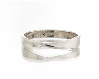 May include: A simple, silver, twisted band wedding ring. The ring is smooth and polished, with a subtle twist design. The inside of the band is marked with the number "14k".