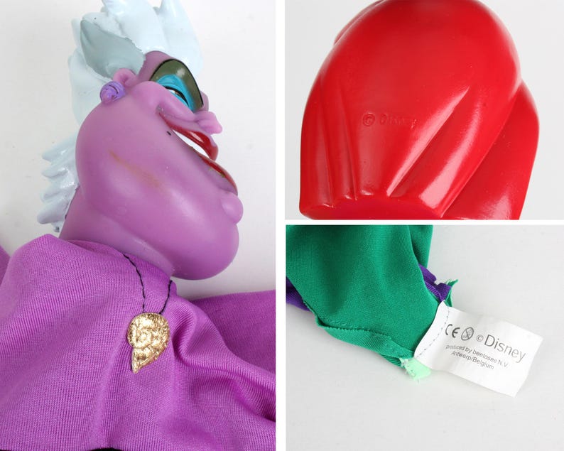 Puede incluir: Mu&ntilde;eca de &Uacute;rsula morada con una diadema blanca y azul, un colgante de concha dorada y una concha roja. La mu&ntilde;eca tiene un vestido morado y mangas verdes y moradas. El logotipo de Disney es visible.