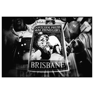 May include: Black and white photo of a flyer for a band called "Machinegirl" from Brisbane, Australia. The flyer features a photo of two people kissing.