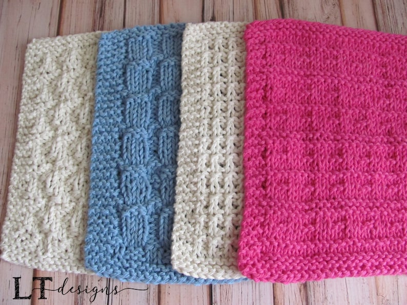 May include: Four knitted dishcloths in different colors and patterns. The dishcloths are beige, blue, beige, and pink.  The dishcloths are made with a textured stitch.
