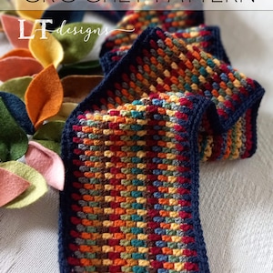 May include: A colorful crochet scarf with a navy blue border and fringe. The scarf is made with a variety of colors, including red, orange, yellow, green, blue, and brown. The scarf is crocheted in a textured stitch.
